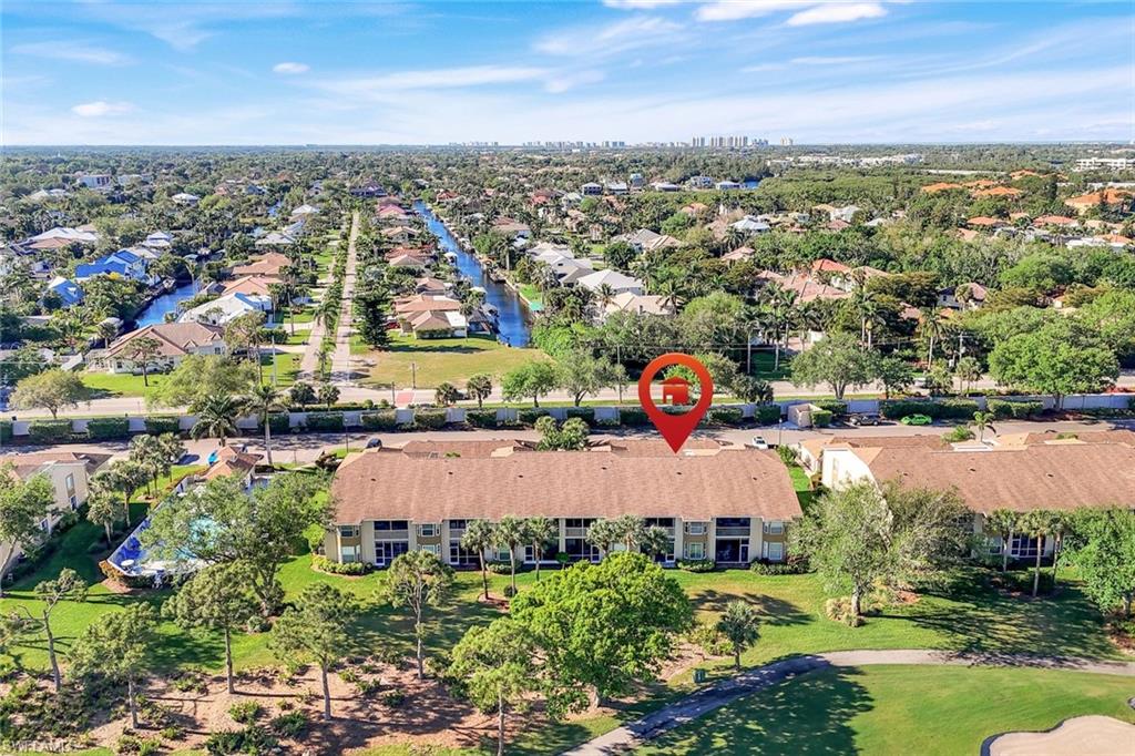 26871 Clarkston Drive, Unit 102 Bonita Springs, FL 34135 - Photo 37 of 50 an aerial view of residential building and lake