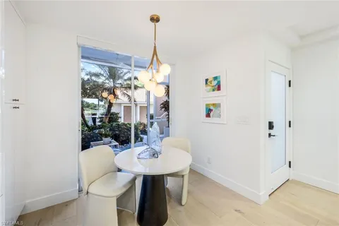 a view of a dining room with a table and chairs