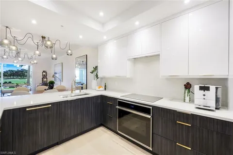a kitchen with a sink a stove and cabinets