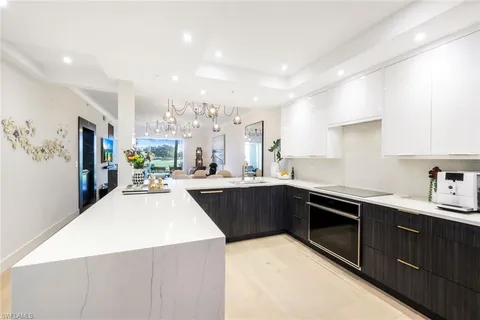 a kitchen with stainless steel appliances kitchen island granite countertop a sink and cabinets