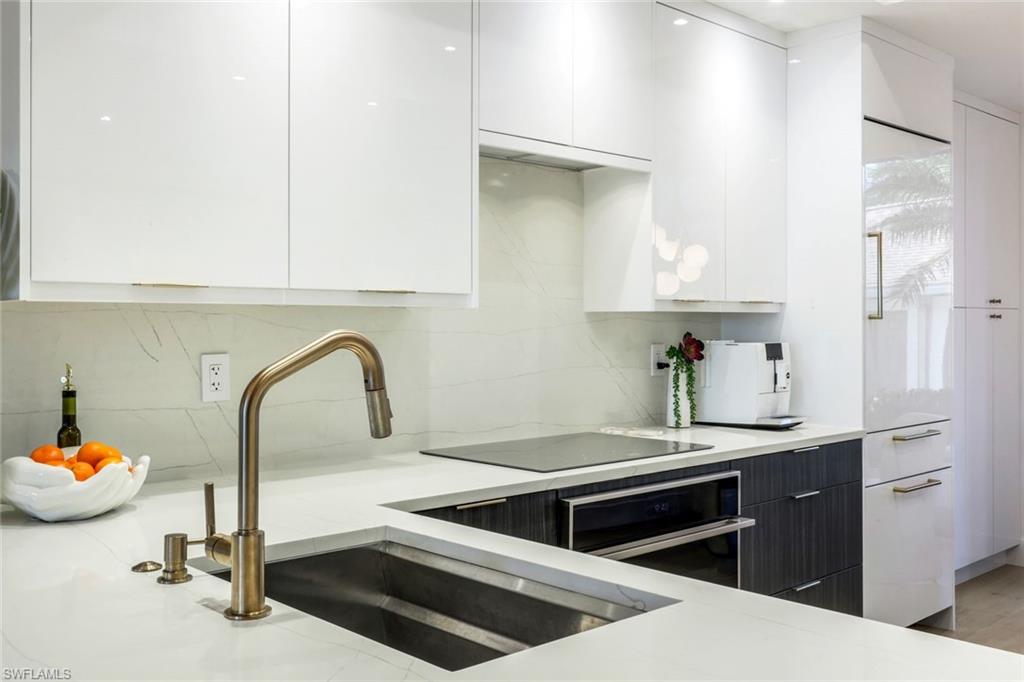 26871 Clarkston Drive, Unit 102 Bonita Springs, FL 34135 - Photo 9 of 50 a kitchen with a sink and cabinets