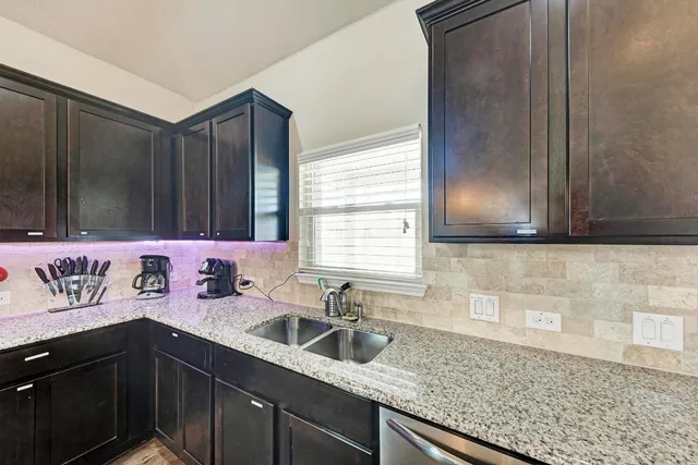 a kitchen with a sink and cabinets