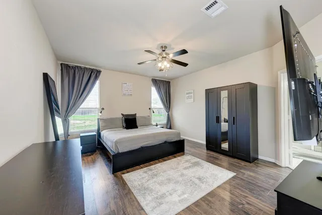 a bedroom with a bed and a chandelier