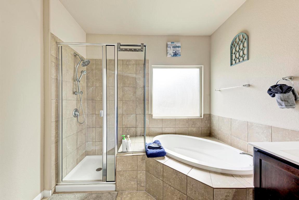 1023 Palo Duro Loop Round Rock, TX 78664 - Photo 18 of 33 Stand up shower and separate soaking tub in the primary bathroom