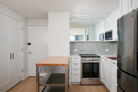 a kitchen with a stove and a refrigerator