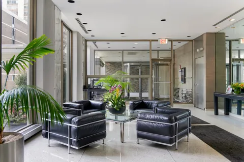 a living room with patio furniture and a potted plant