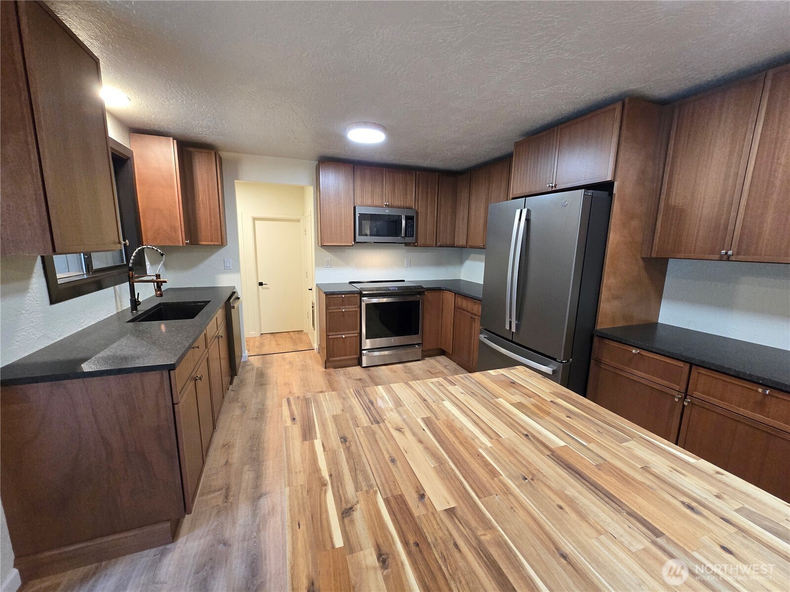 639 Lower Elwha Road Port Angeles, WA 98363 - Photo 12 of 38 a kitchen with stainless steel appliances a sink stove and refrigerator