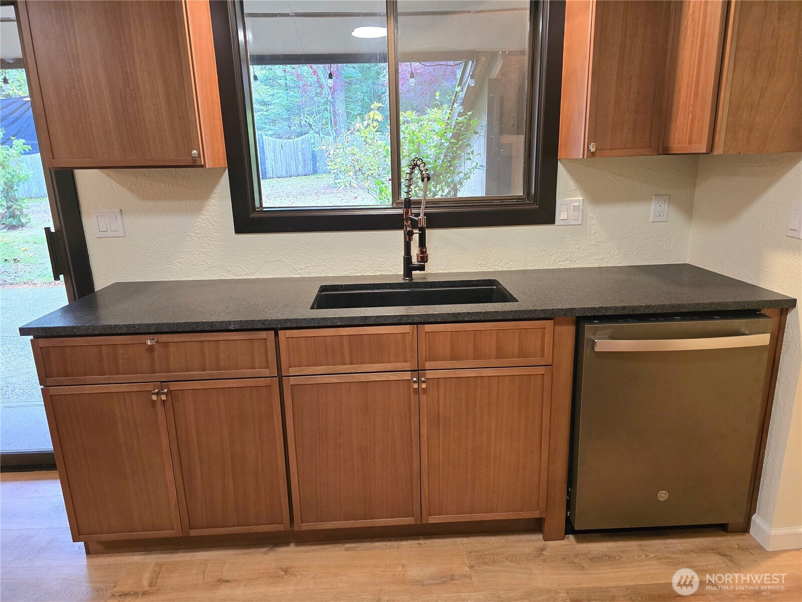 639 Lower Elwha Road Port Angeles, WA 98363 - Photo 16 of 38 a kitchen with stainless steel appliances granite countertop wooden cabinets a sink and a window