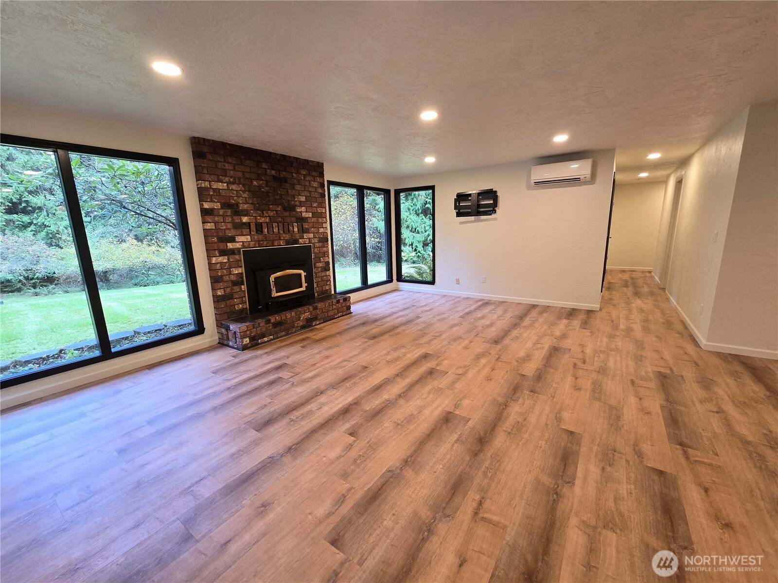 639 Lower Elwha Road Port Angeles, WA 98363 - Photo 17 of 38 a view of empty room with wooden floor and fireplace