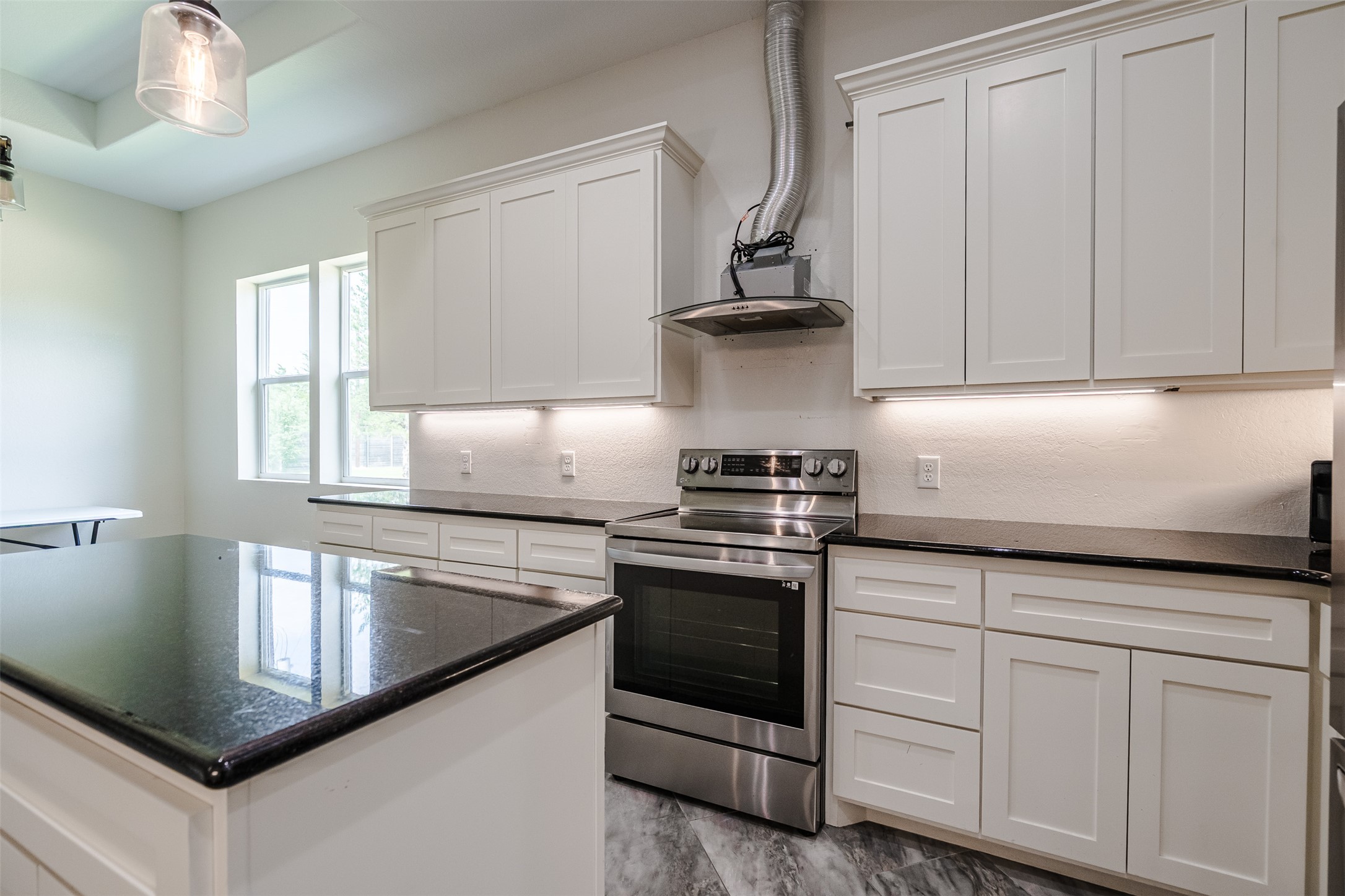 1354 Old Pin Oak Road Paige, TX 78659 - Photo 12 of 37 a kitchen with granite countertop a sink a stove and cabinets