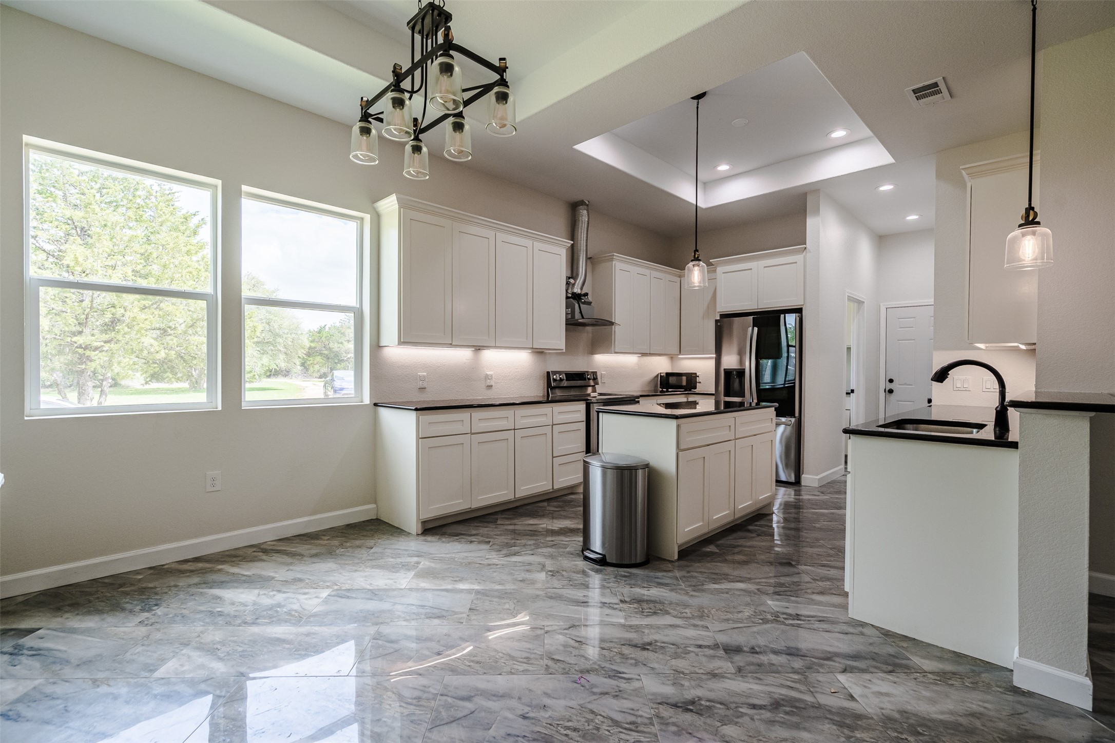 1354 Old Pin Oak Road Paige, TX 78659 - Photo 13 of 37 a kitchen with stainless steel appliances granite countertop a stove a sink dishwasher a refrigerator and white cabinets with wooden floor