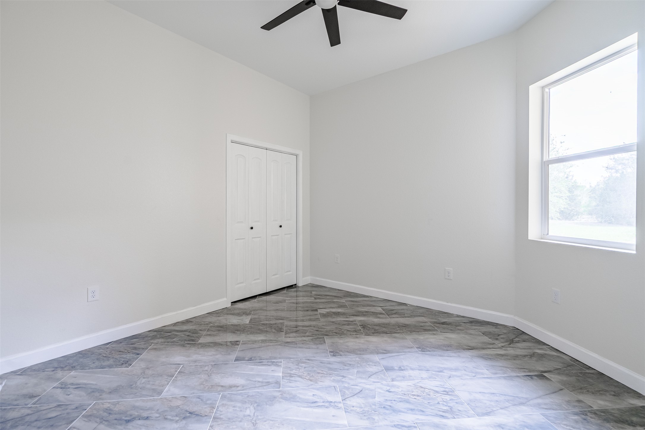 1354 Old Pin Oak Road Paige, TX 78659 - Photo 25 of 37 an empty room with a window and a ceiling fan