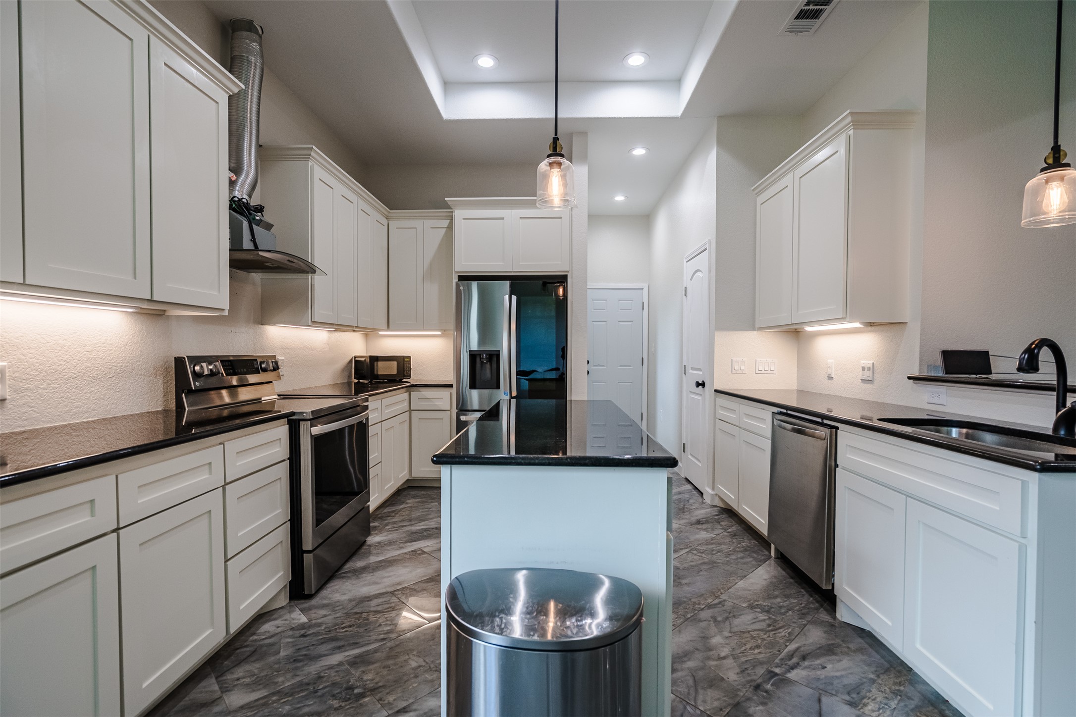 1354 Old Pin Oak Road Paige, TX 78659 - Photo 10 of 37 a kitchen with stainless steel appliances granite countertop a sink a stove a refrigerator and a cabinets