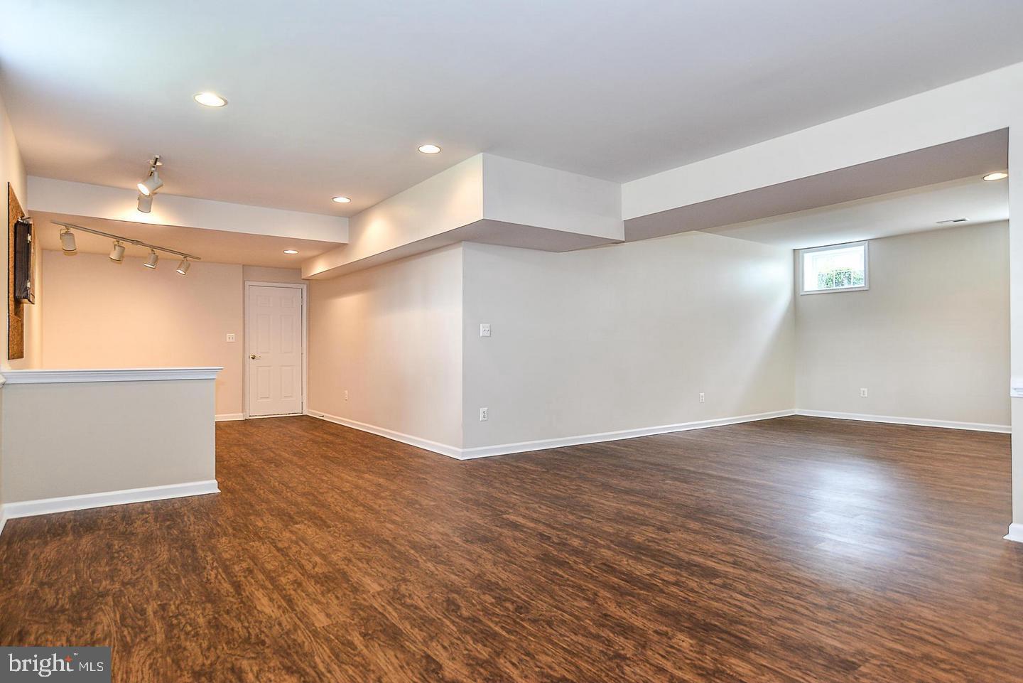 9223 Ox Road Lorton, VA 22079 - Photo 5 of 9 a view of an empty room with wooden floor and a window
