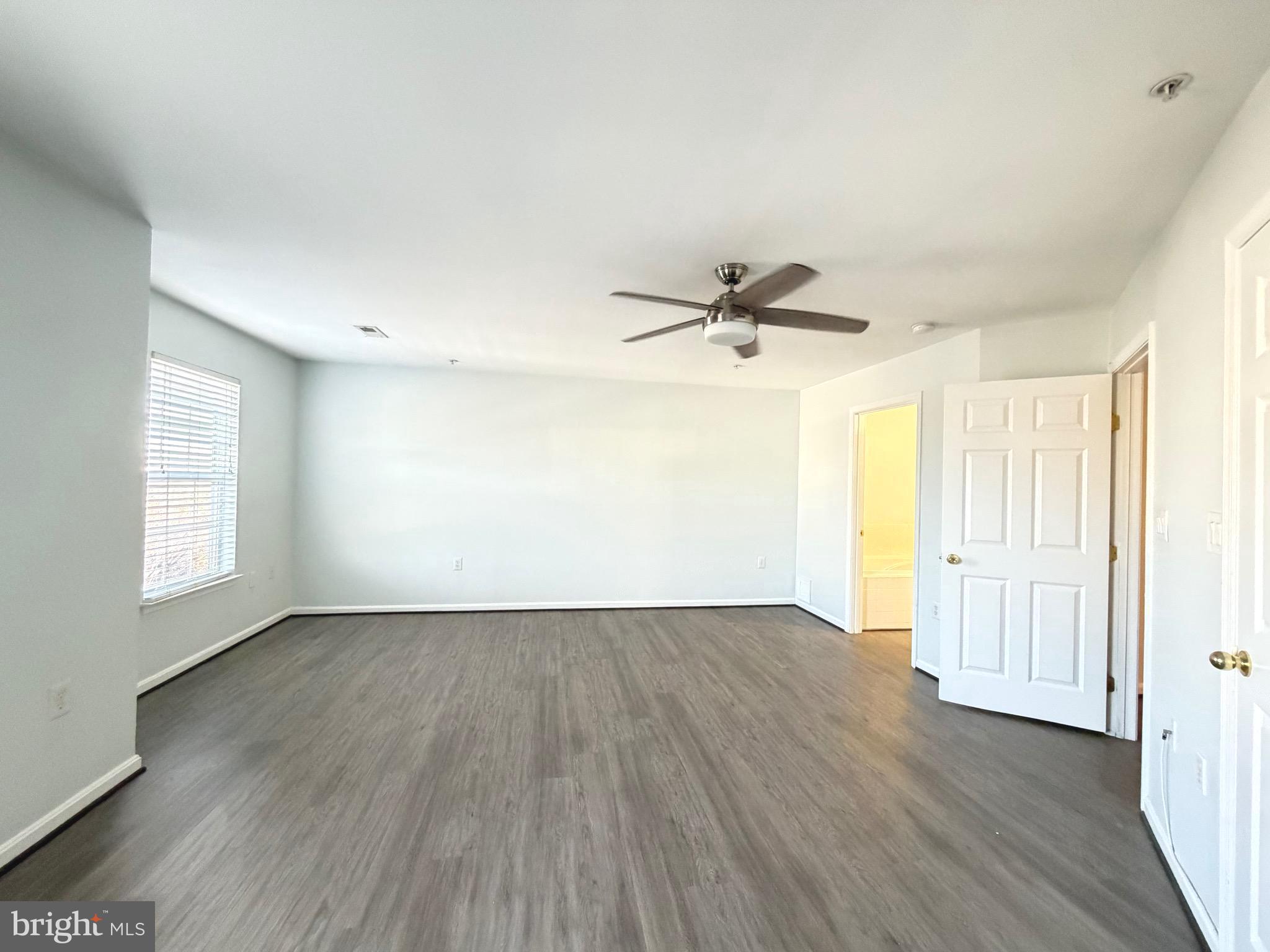 1905 Bulrush Court Odenton, MD 21113 - Photo 11 of 17 an empty room with wooden floor fan and windows