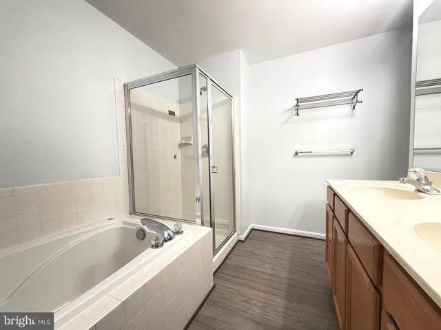 a bathroom with a tub a sink and a shower