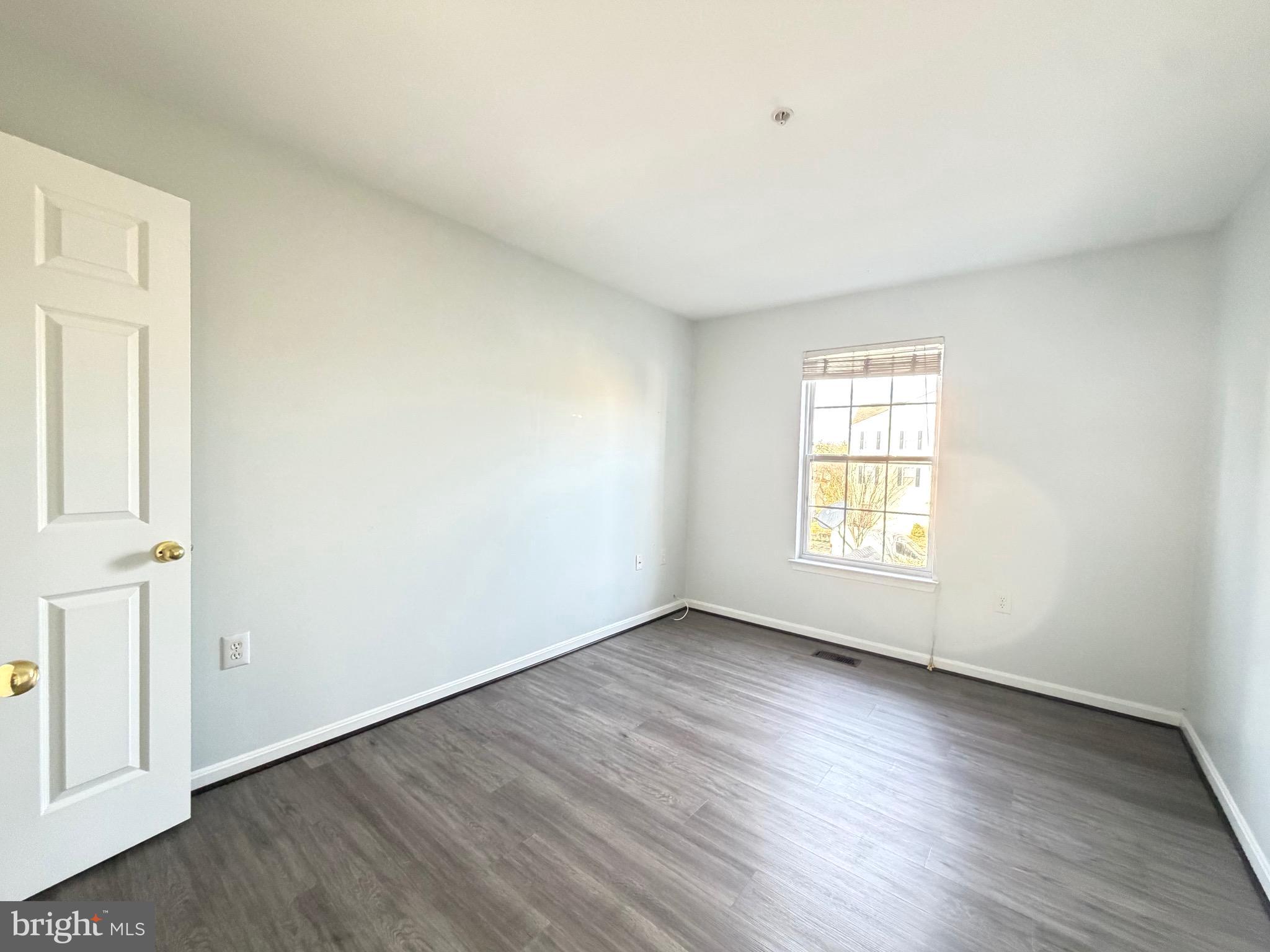 1905 Bulrush Court Odenton, MD 21113 - Photo 14 of 17 an empty room with wooden floor and windows