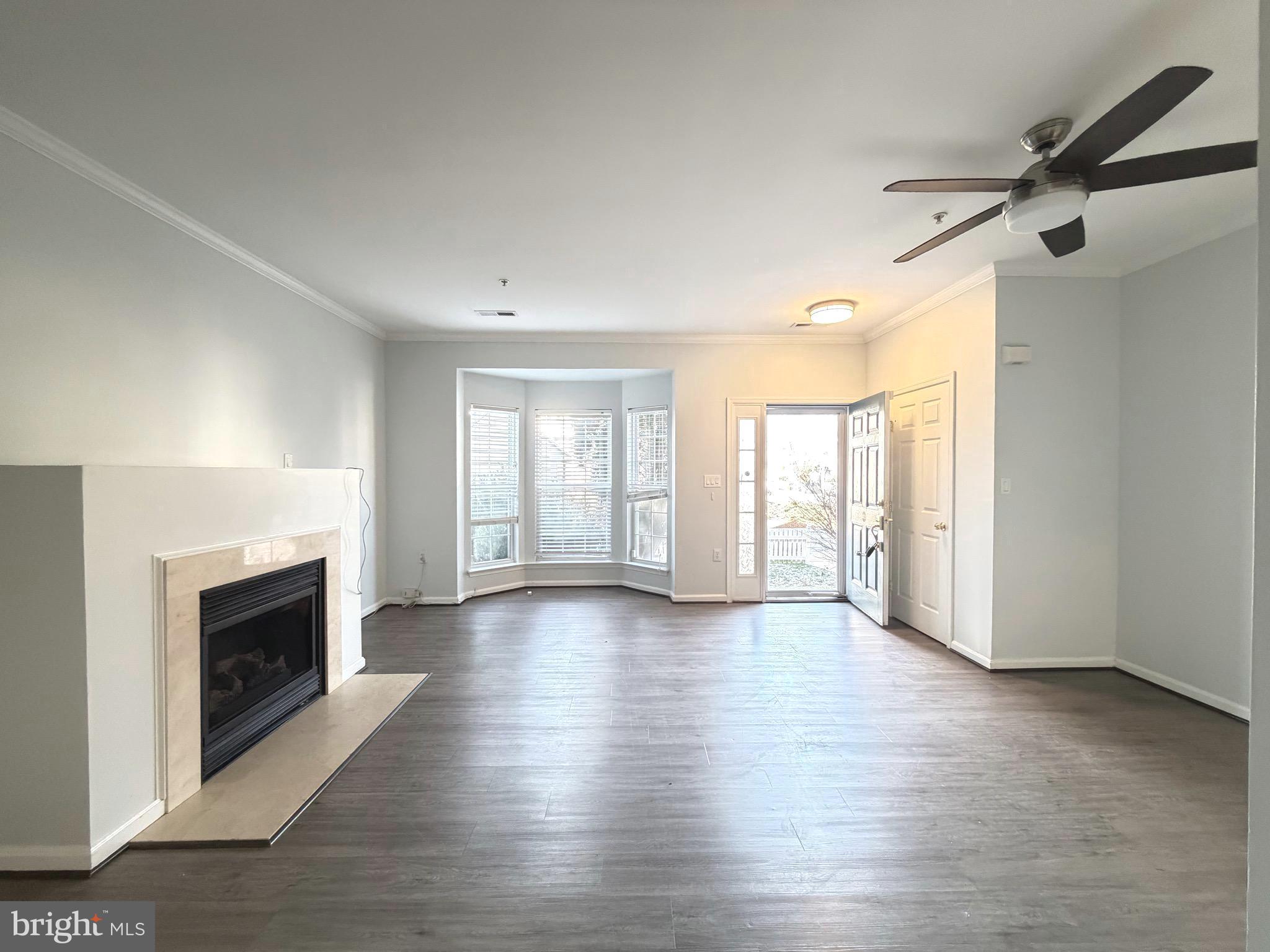 1905 Bulrush Court Odenton, MD 21113 - Photo 3 of 17 an empty room with wooden floor fireplace and windows