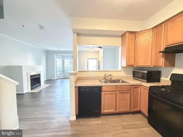 a open kitchen with a sink and cabinets
