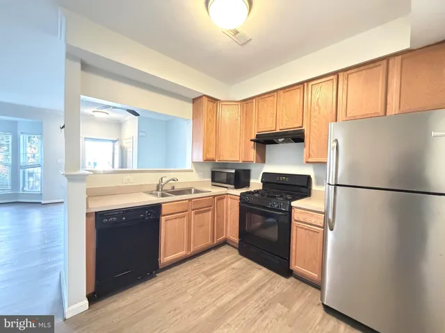 a kitchen with a refrigerator sink and stove