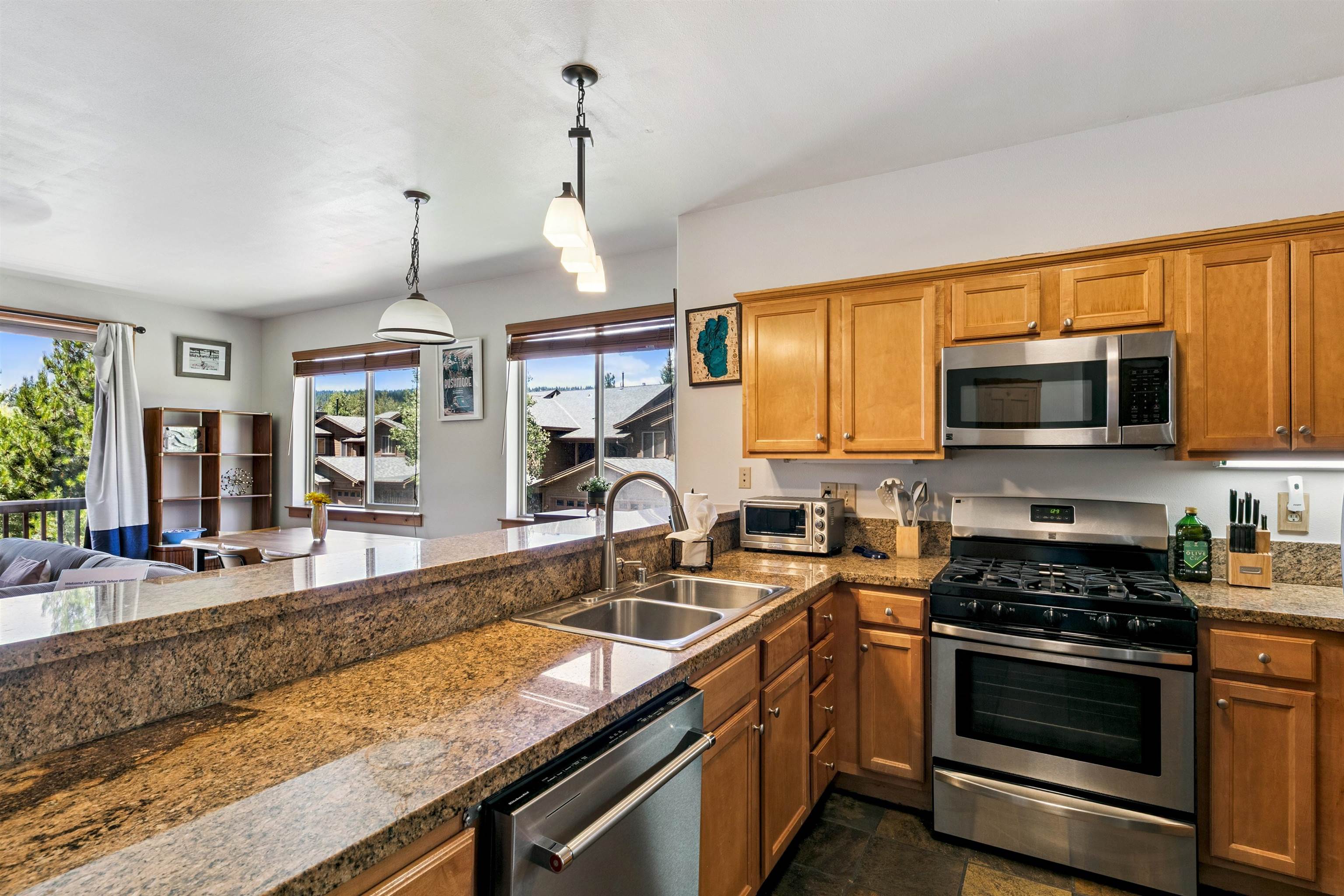 10592 Boulders Road, Unit 8 Truckee, CA 96161 - Photo 13 of 28 a kitchen with granite countertop a sink a counter space appliances and cabinets