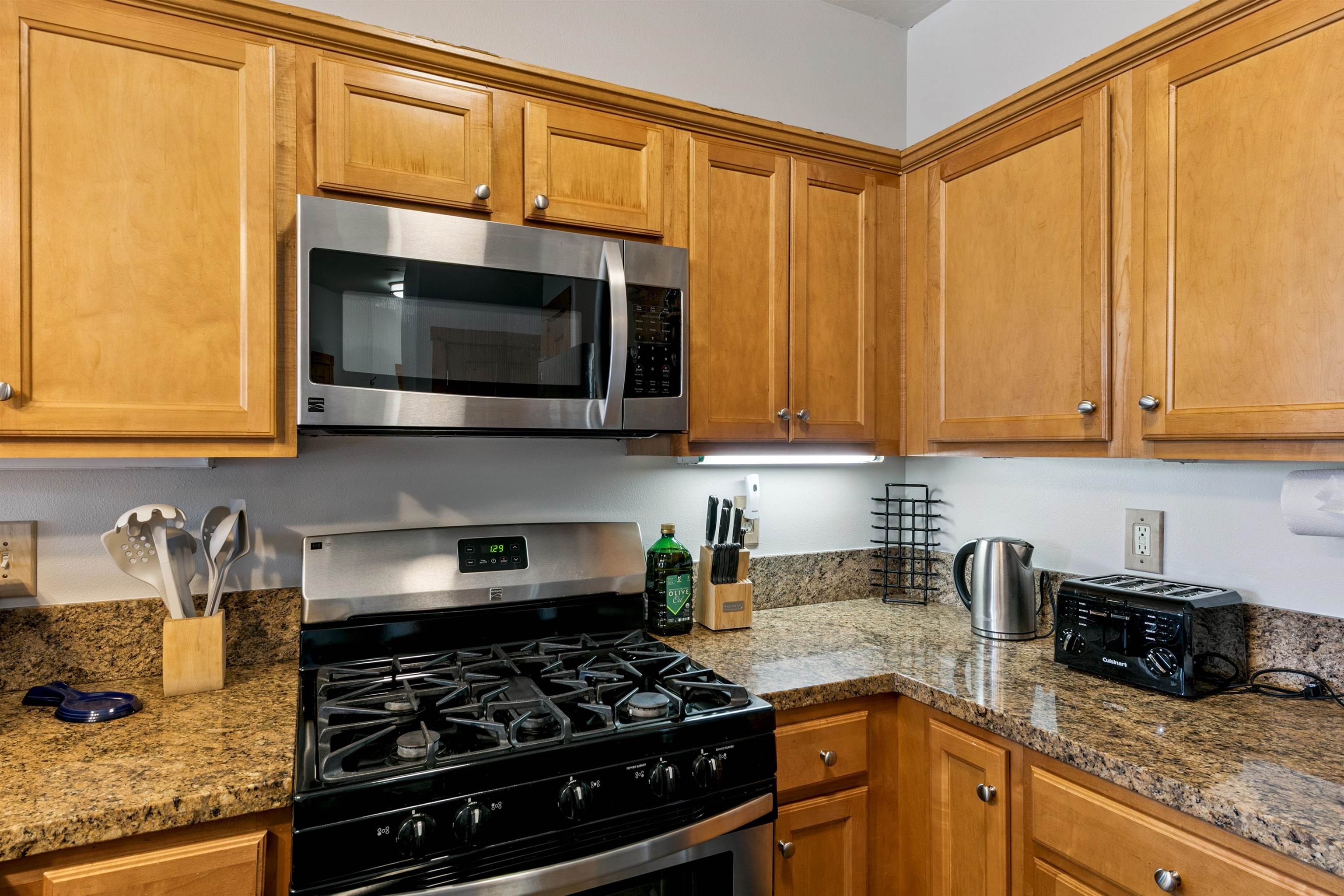 10592 Boulders Road, Unit 8 Truckee, CA 96161 - Photo 15 of 28 a kitchen with stainless steel appliances granite countertop white cabinets and a stove top oven