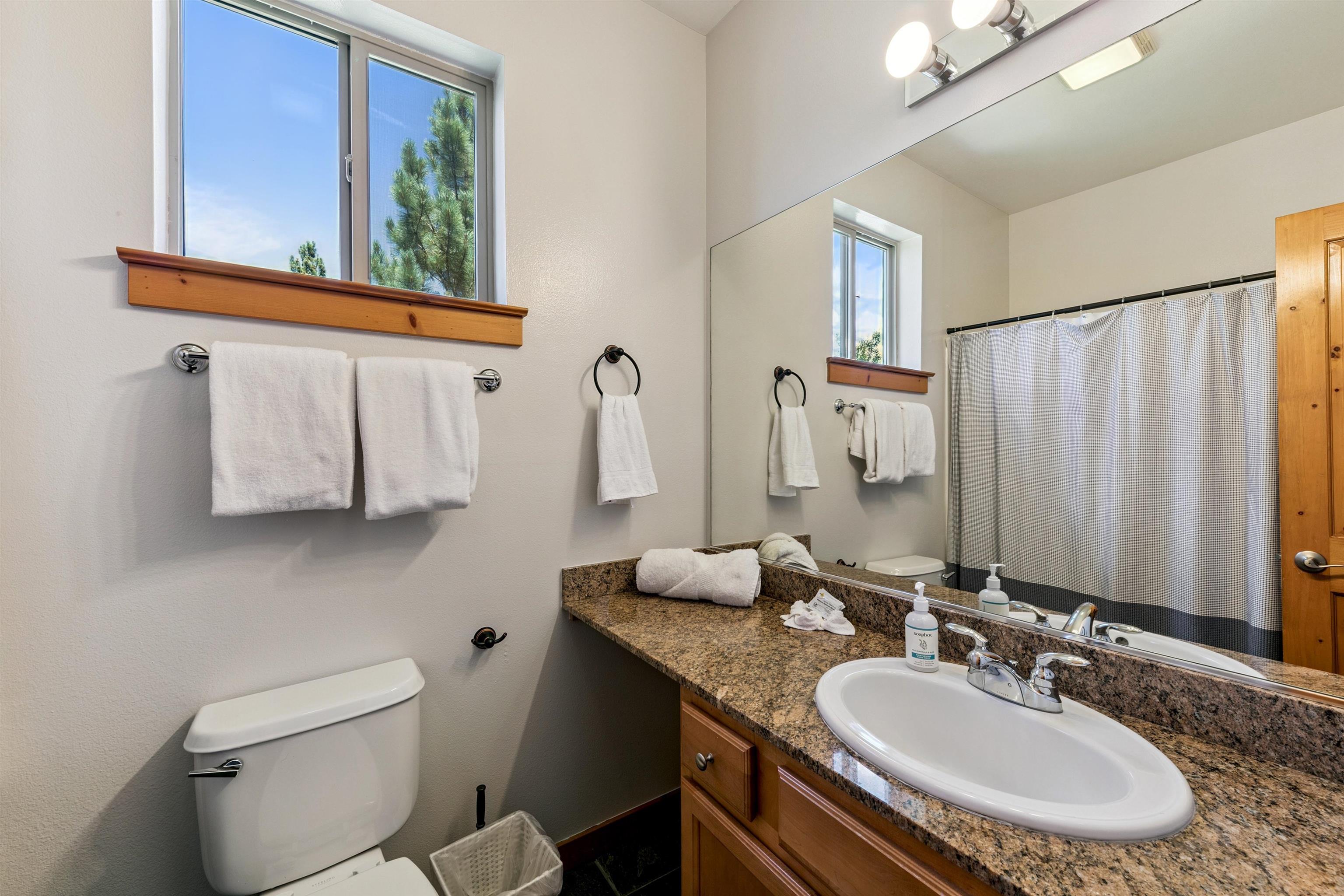 10592 Boulders Road, Unit 8 Truckee, CA 96161 - Photo 21 of 28 a bathroom with a granite countertop sink and a mirror