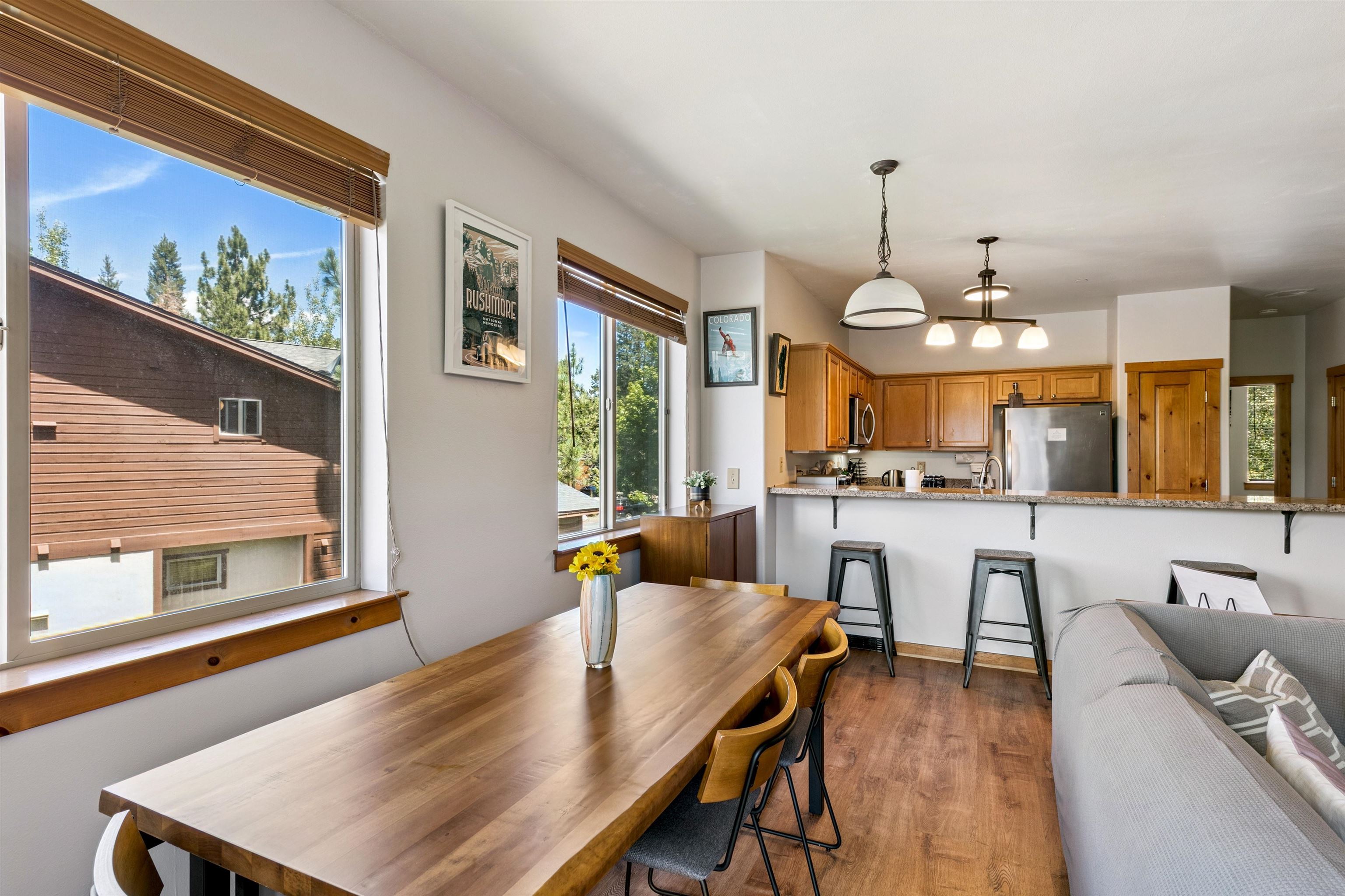 10592 Boulders Road, Unit 8 Truckee, CA 96161 - Photo 9 of 28 a view of a dining room and livingroom with furniture wooden floor a rug a painting and a chandelier