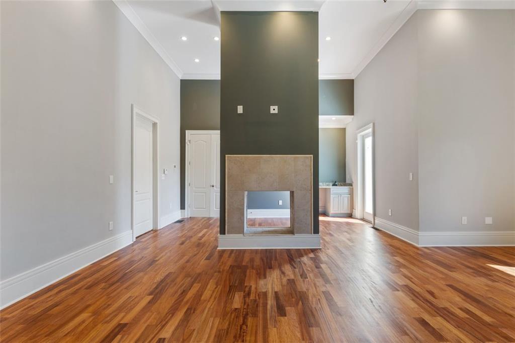 6509 Lily Trail Fairburn, GA 30213 - Photo 25 of 117 a view of a hallway with wooden floor and a fireplace