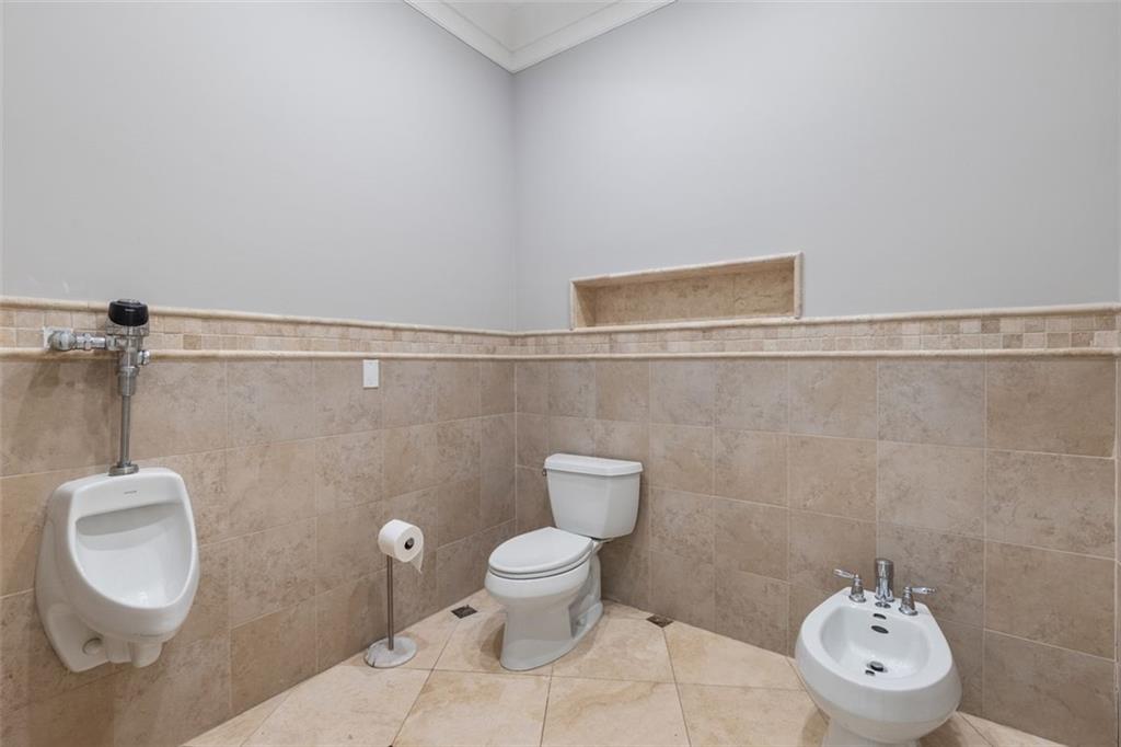 6509 Lily Trail Fairburn, GA 30213 - Photo 29 of 117 a toilet sitting in a bathroom next to a wooden wall