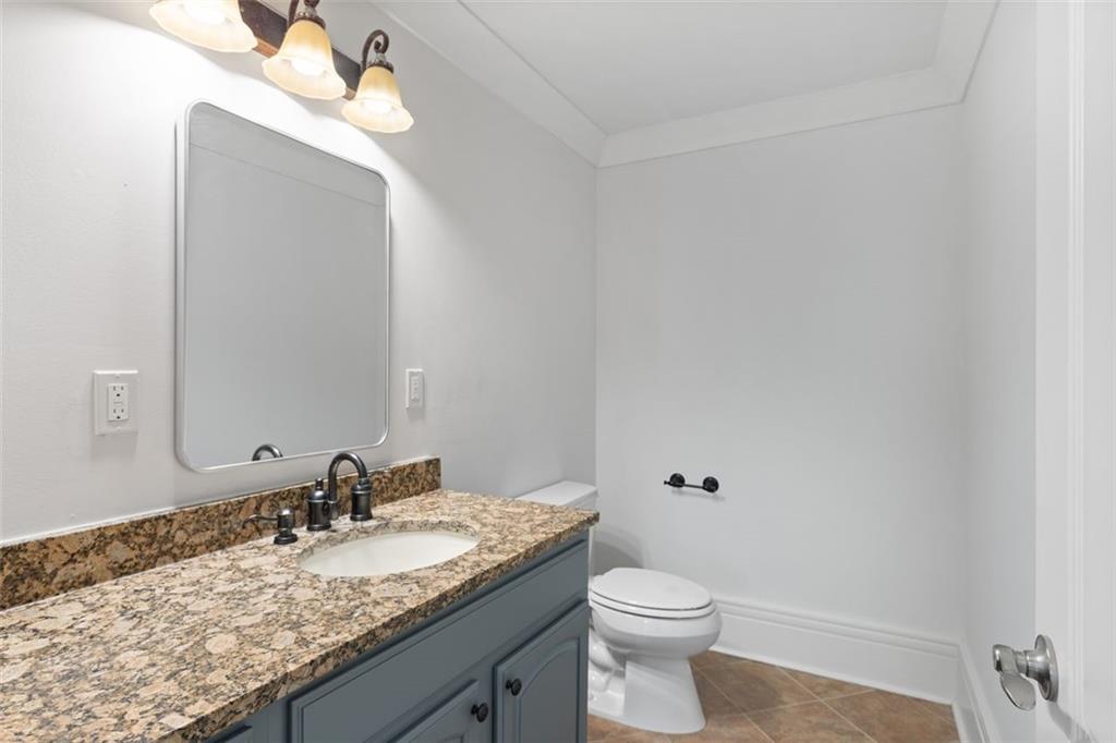 6509 Lily Trail Fairburn, GA 30213 - Photo 40 of 117 a bathroom with a granite countertop sink and a toilet