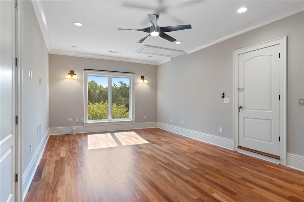 6509 Lily Trail Fairburn, GA 30213 - Photo 55 of 117 a view of an empty room with a window and wooden floor