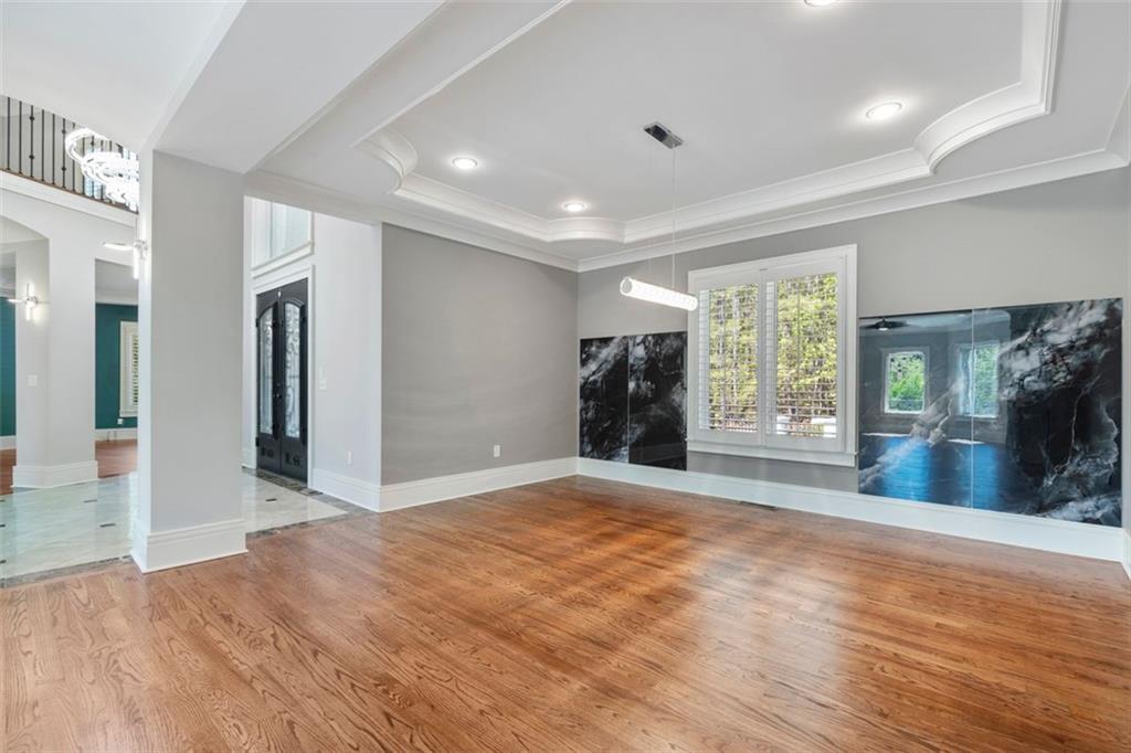 6509 Lily Trail Fairburn, GA 30213 - Photo 7 of 117 a view of an empty room with wooden floor and a window