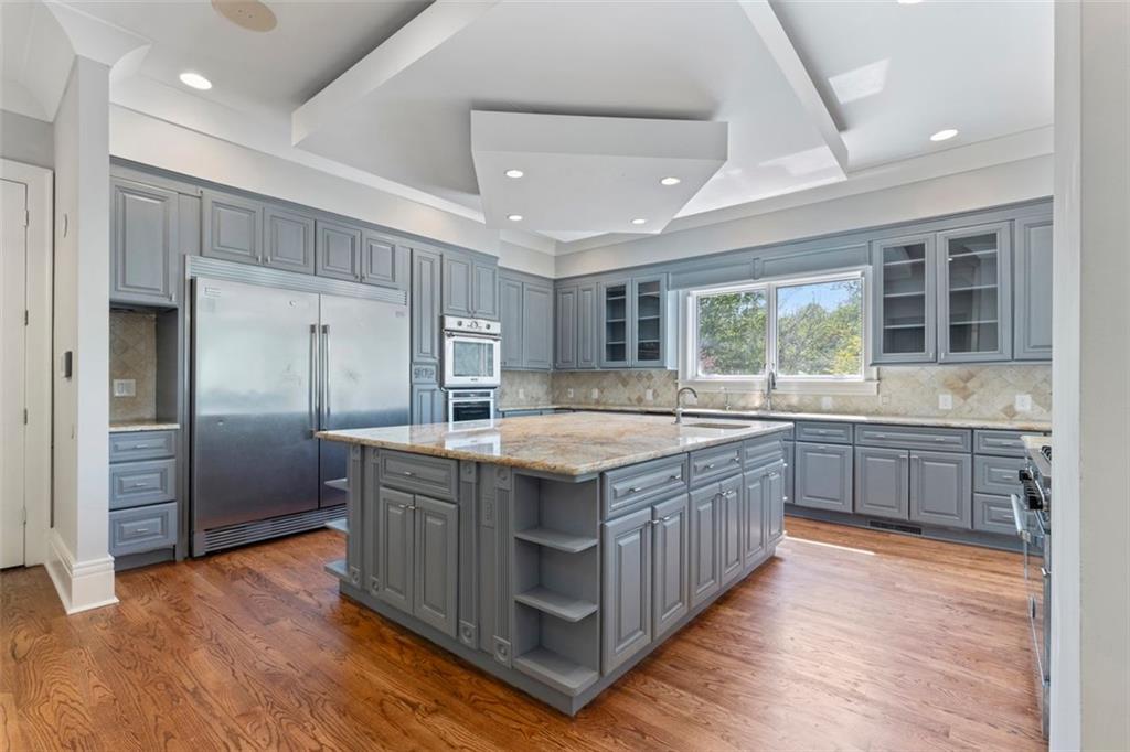 6509 Lily Trail Fairburn, GA 30213 - Photo 8 of 117 a kitchen with stainless steel appliances granite countertop a stove and a refrigerator