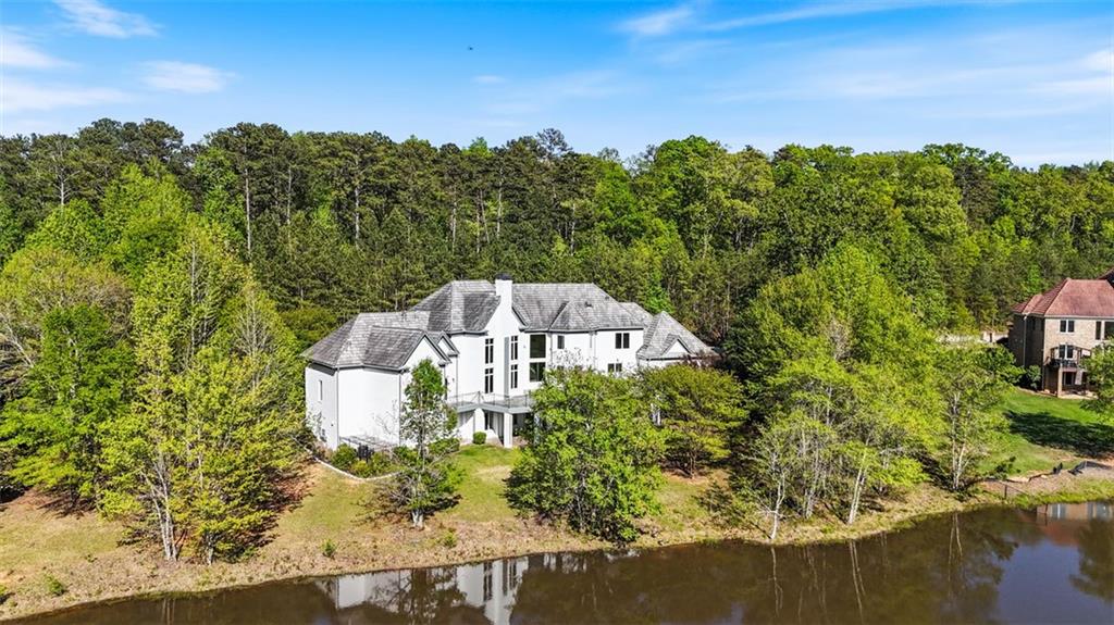 6509 Lily Trail Fairburn, GA 30213 - Photo 82 of 117 a view of a house with a yard and lake view