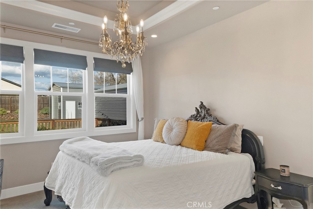 3424 Hackamore Lane Chico, CA 95973 - Photo 29 of 67 a bedroom with a large bed and a chandelier