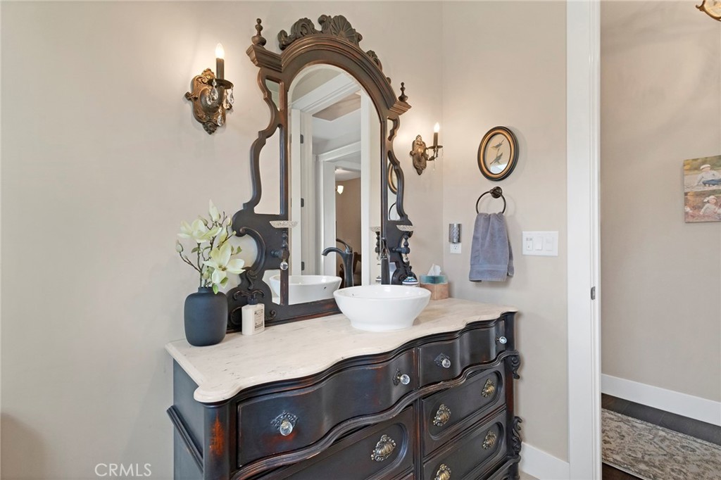 3424 Hackamore Lane Chico, CA 95973 - Photo 42 of 67 a bathroom with a sink a mirror and a potted plant