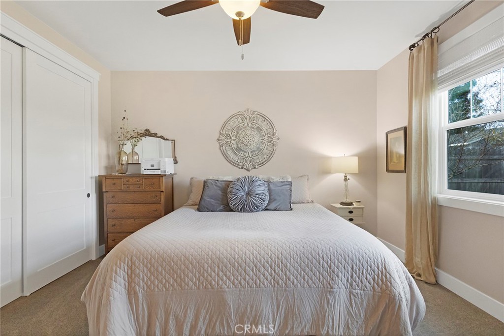 3424 Hackamore Lane Chico, CA 95973 - Photo 45 of 67 a bedroom with a bed a lamp and a window