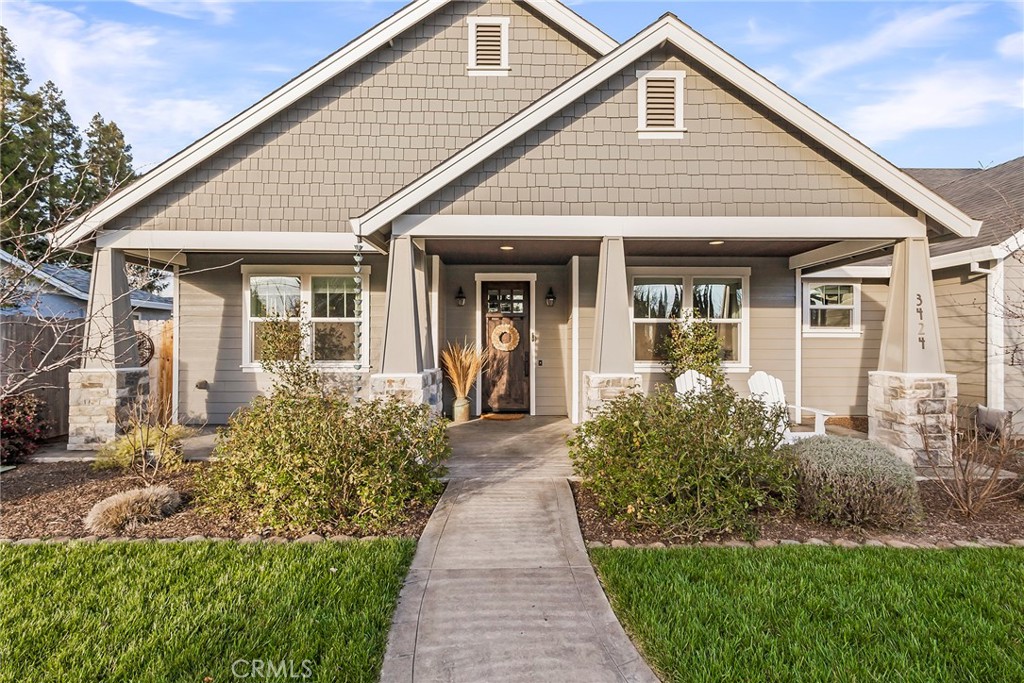 3424 Hackamore Lane Chico, CA 95973 - Photo 5 of 67 a front view of a house with a yard and potted plants