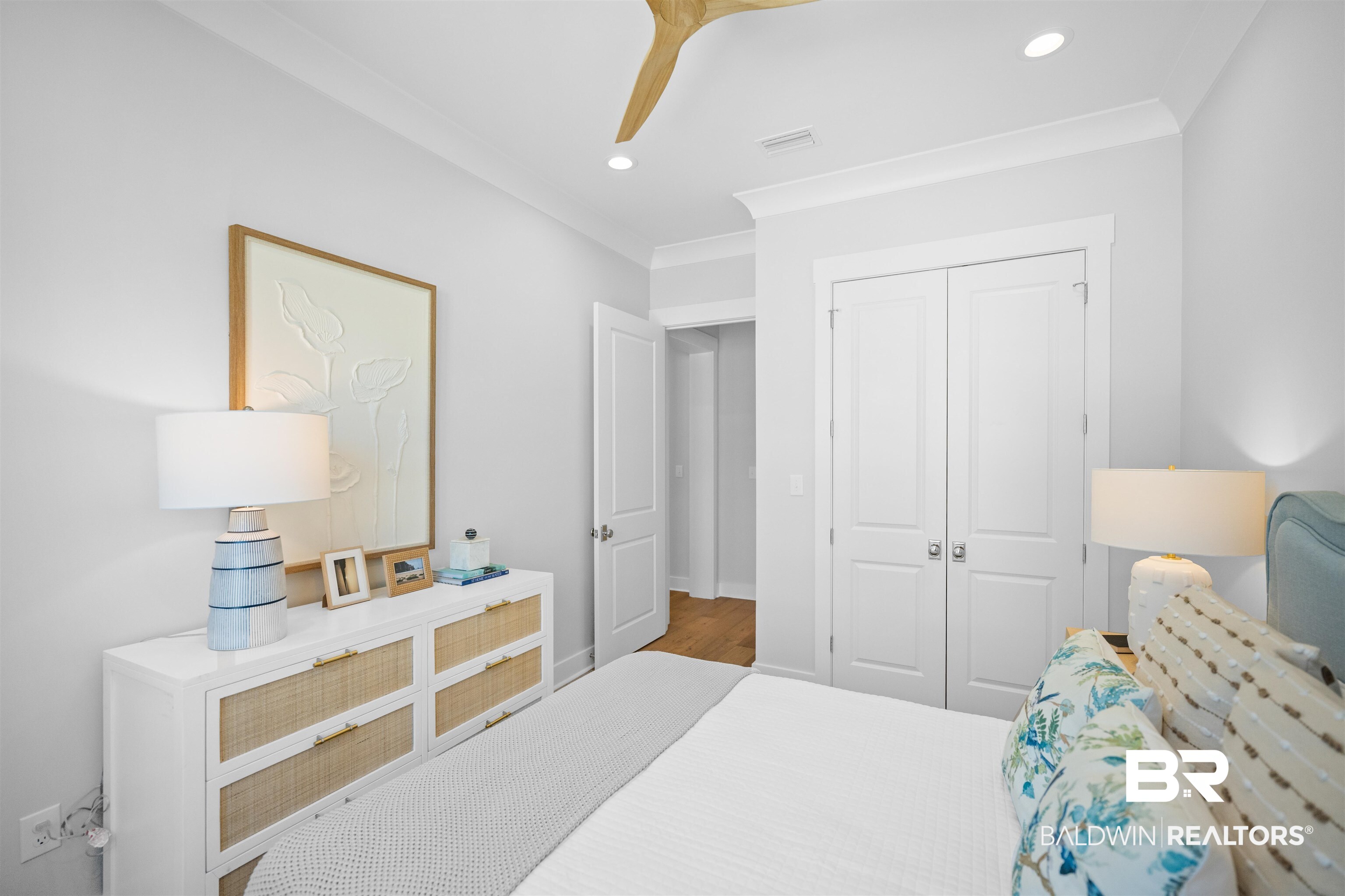 156 Hyacinth Street Fairhope, AL 36532 - Photo 47 of 61 Bedroom with recessed lighting, crown molding, a closet, and wood finished floors
