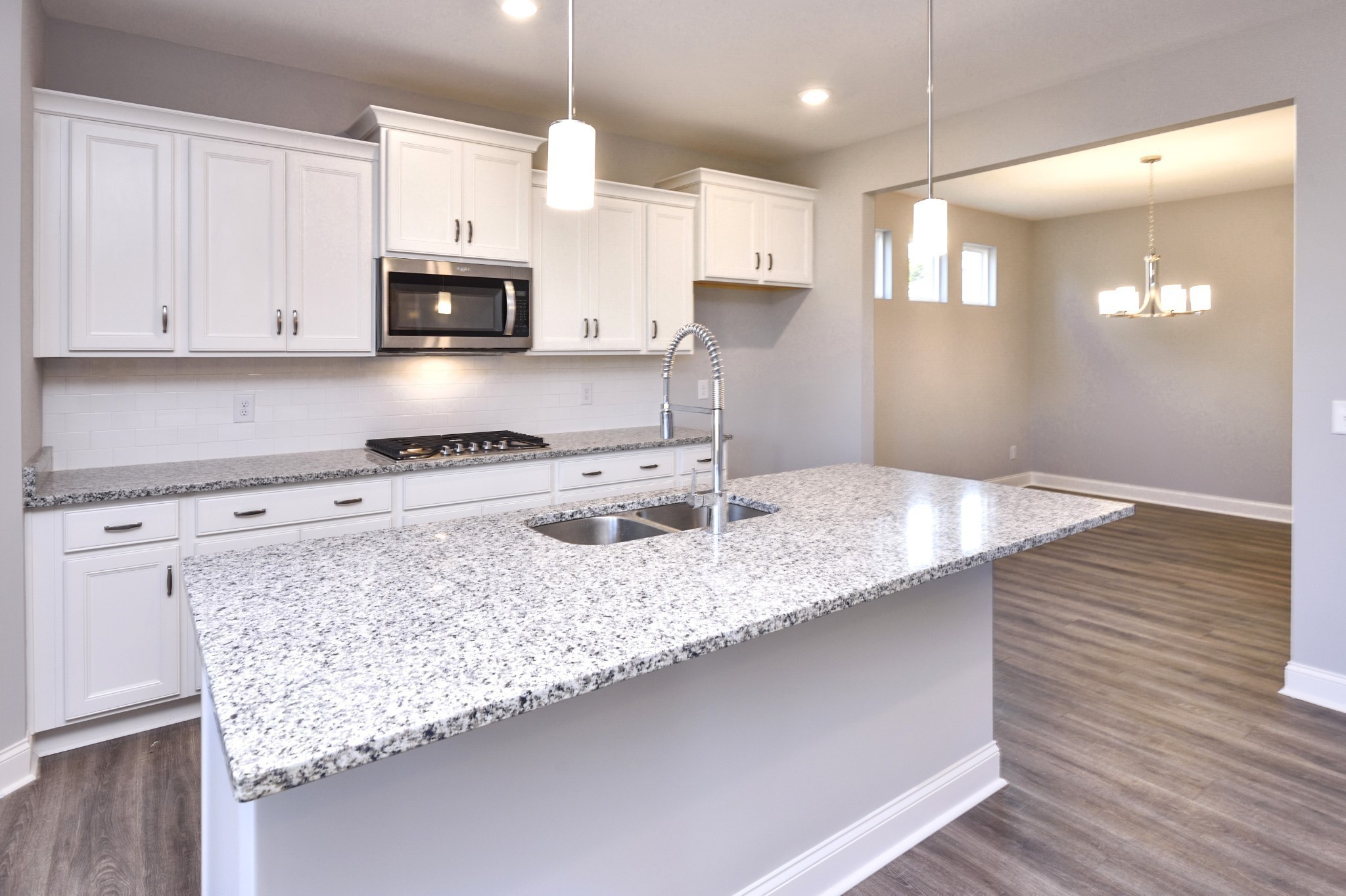 74 Remington Road Lebanon, TN 37090 - Photo 6 of 25 a kitchen with stainless steel appliances granite countertop a sink a stove and white cabinets