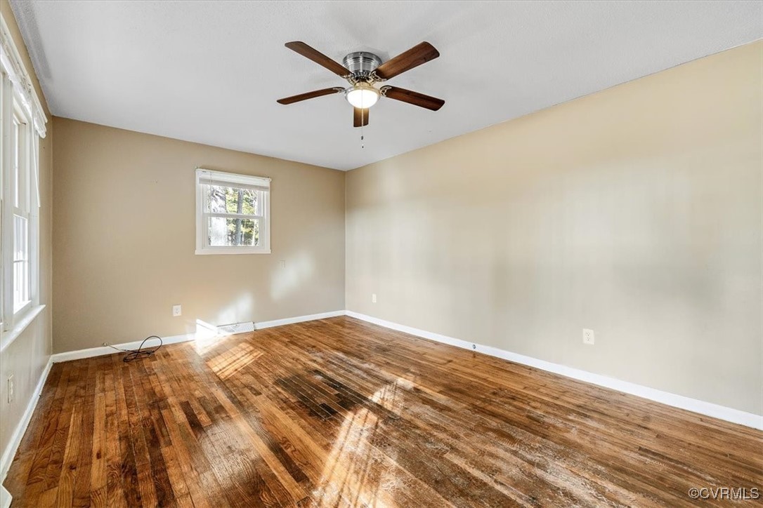 21814 Carson Road Dinwiddie, VA 23841 - Photo 11 of 24 a view of a livingroom with wooden floor and a ceiling fan
