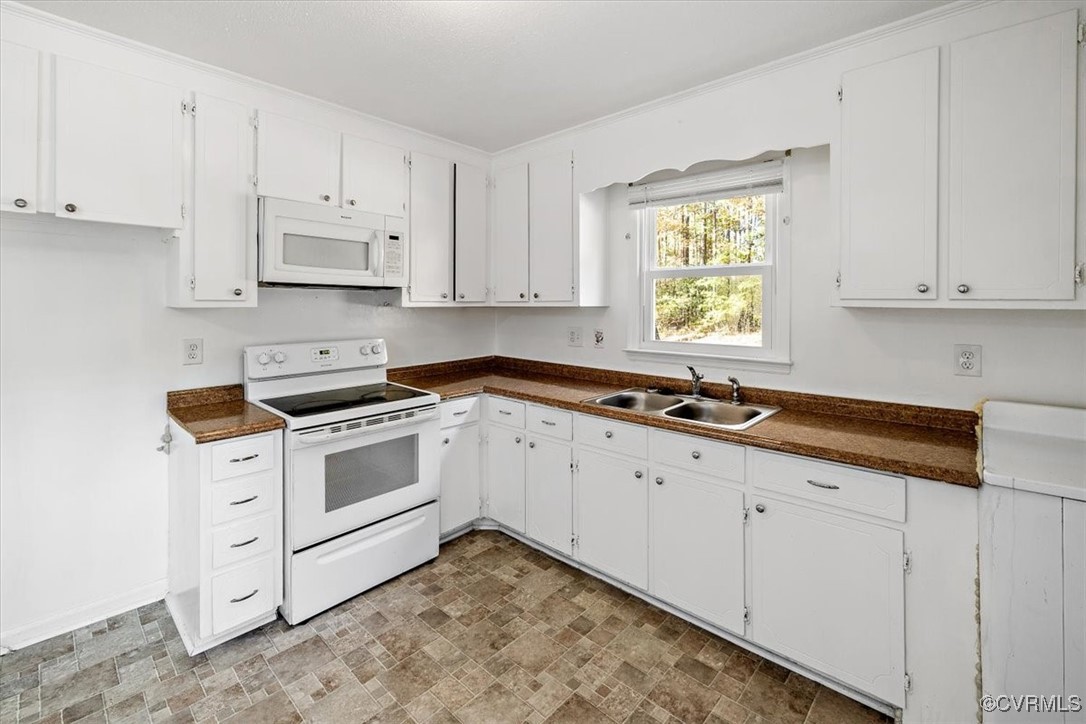 21814 Carson Road Dinwiddie, VA 23841 - Photo 14 of 24 a kitchen with granite countertop white cabinets and white appliances