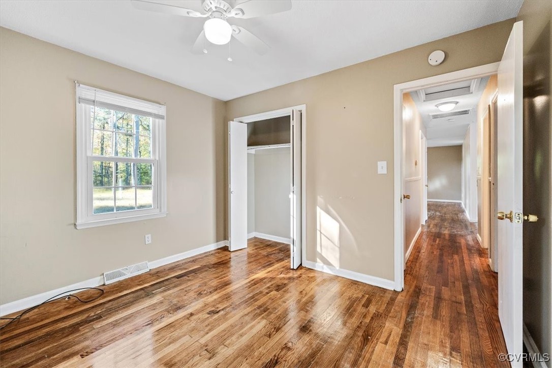 21814 Carson Road Dinwiddie, VA 23841 - Photo 17 of 24 a view of an empty room with wooden floor and a window