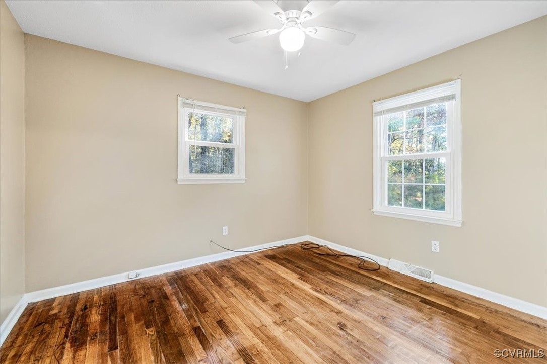 21814 Carson Road Dinwiddie, VA 23841 - Photo 18 of 24 a view of a big room with wooden floor and windows