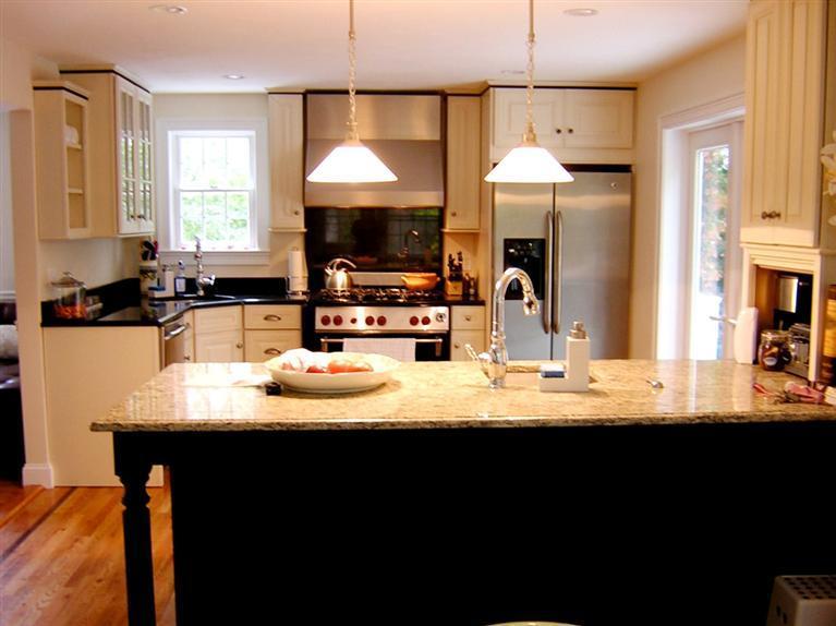 129 Summersea Road Mashpee, MA 02649 - Photo 2 of 6 a kitchen with kitchen island granite countertop a sink cabinets and a fireplace