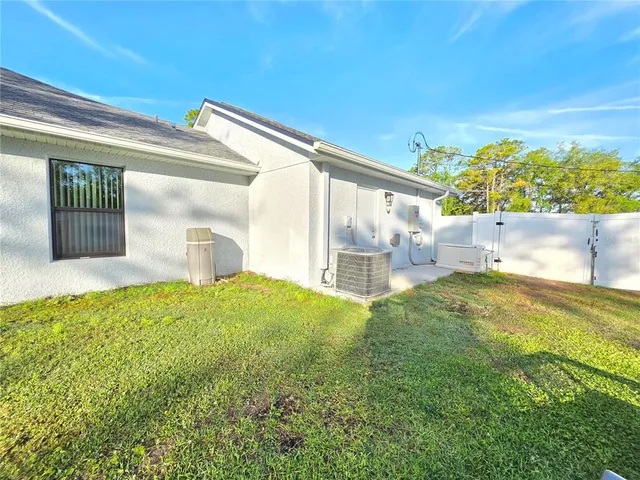 a view of pool with a big yard and large trees