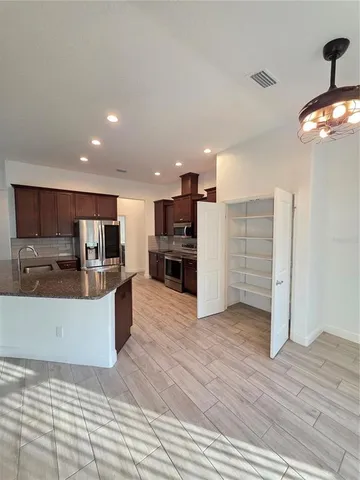 a view of kitchen with cabinets and wooden floor