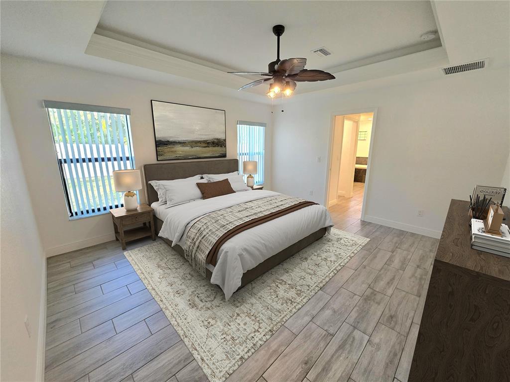 11240 Marvelwood Road Weeki Wachee, FL 34614 - Photo 5 of 21 a bedroom with a large bed and a chandelier