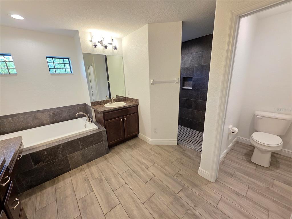 11240 Marvelwood Road Weeki Wachee, FL 34614 - Photo 8 of 21 a bathroom with a sink and a mirror